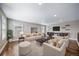 Spacious living room featuring ample seating, hardwood floors, and custom built-ins perfect for relaxing at 7720 S Queensburg Way, Aurora, CO 80016