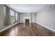 Spacious living room featuring a fireplace, large windows, and hardwood floors at 7720 S Queensburg Way, Aurora, CO 80016