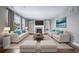Stylishly furnished living room with fireplace, hardwood floors, and ample seating at 7720 S Queensburg Way, Aurora, CO 80016