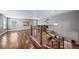 Bright living room featuring hardwood floors and elegant staircase with iron balusters, perfect for entertaining at 7720 S Queensburg Way, Aurora, CO 80016