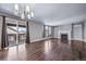 Bright living room with hardwood floors, fireplace, large windows, and access to outdoor deck at 7720 S Queensburg Way, Aurora, CO 80016