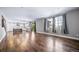 Open-concept living area with hardwood floors, modern finishes, and an attached kitchen at 7720 S Queensburg Way, Aurora, CO 80016