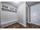 Mudroom features hardwood floors, coat hooks, storage cabinets, and white trim at 7720 S Queensburg Way, Aurora, CO 80016