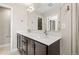 Modern bathroom featuring a double sink vanity with sleek hardware and a large mirror at 1615 Harlan St # 2, Lakewood, CO 80214