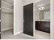 Bathroom with a dark vanity, walk-in closet and modern finishes at 1615 Harlan St # 2, Lakewood, CO 80214