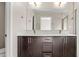 Bathroom features a double vanity with dark wood cabinets and modern fixtures at 1615 Harlan St # 2, Lakewood, CO 80214