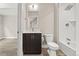 Bright bathroom featuring a modern vanity, and tiled tub with a shower head at 1615 Harlan St # 2, Lakewood, CO 80214