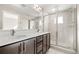 Contemporary bathroom featuring a double sink vanity and a frameless glass shower at 1615 Harlan St # 2, Lakewood, CO 80214