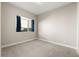 Bright bedroom with carpet, a window with curtains, and neutral walls at 1615 Harlan St # 2, Lakewood, CO 80214