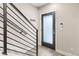 Entryway featuring modern black railings and a glass paneled front door at 1615 Harlan St # 2, Lakewood, CO 80214