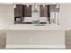 Modern kitchen boasts an island, stainless appliances, and dark wood cabinetry at 1615 Harlan St # 2, Lakewood, CO 80214