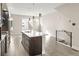 Modern kitchen with an island, stainless steel appliances and light wood floors at 1615 Harlan St # 2, Lakewood, CO 80214