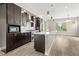Spacious kitchen with dark wood cabinets, a white countertop island and stainless steel appliances at 1615 Harlan St # 2, Lakewood, CO 80214
