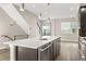Open kitchen with an island, stainless steel appliances, and light wood floors at 1615 Harlan St # 2, Lakewood, CO 80214