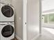 Modern laundry room features a stacked washer and dryer unit maximizing space and efficiency at 1615 Harlan St # 2, Lakewood, CO 80214