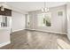 Sunlit living room features wood flooring, large windows, and modern design at 1615 Harlan St # 2, Lakewood, CO 80214