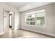 Modern living room featuring wood-look floors, a large window, and a sleek entryway at 1615 Harlan St # 2, Lakewood, CO 80214