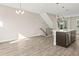 Bright living room featuring wood floors, modern lighting, and staircase at 1615 Harlan St # 2, Lakewood, CO 80214