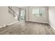 Open-concept living area with wood flooring, staircase, and sliding glass door at 1615 Harlan St # 2, Lakewood, CO 80214