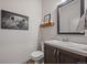 Stylish half bathroom featuring a modern vanity, decorative mirror, and charming decorative elements at 1100 Blue Bell Rd, Berthoud, CO 80513