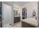 Modern bathroom featuring double sink vanity, walk-in closet, and neutral color palette at 1100 Blue Bell Rd, Berthoud, CO 80513