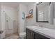Bathroom with shower, wooden mermaid wall art, and dark wood vanity at 1100 Blue Bell Rd, Berthoud, CO 80513