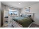 Cozy bedroom featuring a window with neighborhood views, light wood furniture and a mirror at 1100 Blue Bell Rd, Berthoud, CO 80513