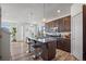 Open kitchen featuring granite countertops, stainless steel appliances, a center island with seating, and hardwood floors at 1100 Blue Bell Rd, Berthoud, CO 80513