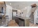 Spacious kitchen with granite countertops, stainless steel appliances, a large island, and an adjacent staircase at 1100 Blue Bell Rd, Berthoud, CO 80513