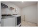Well-equipped laundry room with modern washer and dryer, and ample shelving at 1100 Blue Bell Rd, Berthoud, CO 80513