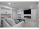 Cozy living room with fireplace, large TV, comfortable seating, and built in shelving at 1100 Blue Bell Rd, Berthoud, CO 80513