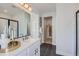 Bright bathroom featuring a modern vanity, large mirror, and glass enclosed shower at 4102 Estrella St, Brighton, CO 80601