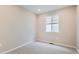 An empty bedroom with light gray carpet, neutral walls, and a window, ready for personalization at 4102 Estrella St, Brighton, CO 80601