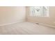 The bedroom features neutral carpeting and paint, with a window providing natural light, creating a cozy atmosphere at 4102 Estrella St, Brighton, CO 80601