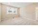 Spacious bedroom with neutral carpet and paint, and a large window allowing ample natural light in the living space at 4102 Estrella St, Brighton, CO 80601