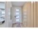 Bright entryway with a modern front door, statement mirror, and custom woodwork at 4102 Estrella St, Brighton, CO 80601