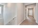 A bright hallway with wood flooring and white walls leads to various rooms in the house at 4102 Estrella St, Brighton, CO 80601