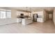 Bright kitchen featuring stainless steel appliances, white cabinetry, and a center island with pendant lighting at 4102 Estrella St, Brighton, CO 80601