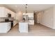 Modern kitchen with white cabinets, stainless steel appliances, and island, showcasing open-concept design at 4102 Estrella St, Brighton, CO 80601