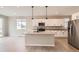 Contemporary kitchen with center island, stainless steel refrigerator and pendant lights at 4102 Estrella St, Brighton, CO 80601