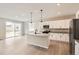 Modern kitchen featuring white cabinetry, a kitchen island, and stainless steel appliances at 4102 Estrella St, Brighton, CO 80601