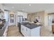 Contemporary kitchen featuring a center island with seating, stainless steel appliances, and sleek dark countertops at 4102 Estrella St, Brighton, CO 80601