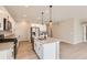 Stylish kitchen featuring stainless appliances, a center island with a sink, and contemporary pendant lights at 4102 Estrella St, Brighton, CO 80601