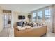 Elegant living room featuring a comfortable leather sofa, stylish decor, and large windows offering abundant natural light at 4102 Estrella St, Brighton, CO 80601