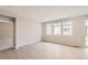 Spacious living room with multiple windows and light wood-look flooring at 4102 Estrella St, Brighton, CO 80601