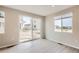 The living room has large windows and a sliding glass door, offering lots of natural light and views of the neighborhood at 4102 Estrella St, Brighton, CO 80601