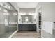 Modern bathroom features double vanity sinks, a glass-enclosed shower, and a walk-in closet at 5839 Hay Market Trl, Parker, CO 80134