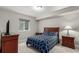Bedroom with hardwood furniture, blue patterned bedding and a window at 5839 Hay Market Trl, Parker, CO 80134