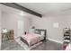 Cozy bedroom with concrete floors and a colorful floral patterned bedspread at 5839 Hay Market Trl, Parker, CO 80134