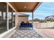Relax on the covered patio featuring an outdoor rug and comfortable blue furniture, perfect for lounging at 5839 Hay Market Trl, Parker, CO 80134